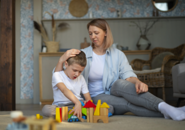 mother-playing-with-her-autistic-son-using-toys