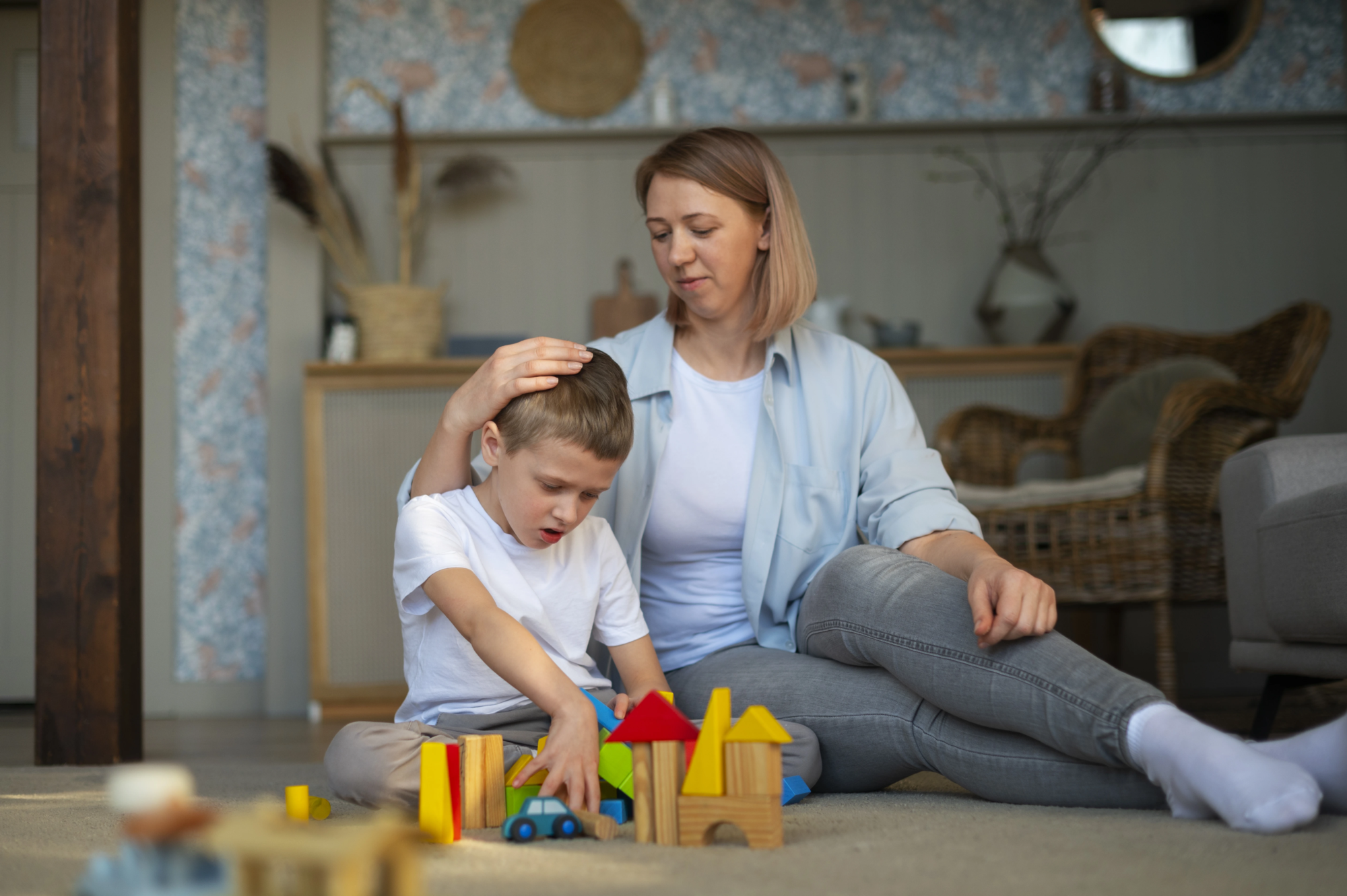 mother-playing-with-her-autistic-son-using-toys